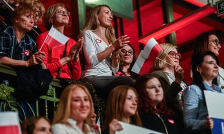Members of the public listen to Donald Tusk delivering a speech during a Women for Elections campaign rally on 10 October in Lodz