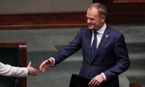 Newly appointed Polish prime minister Donald Tusk is greeted before presenting his government’s programme in parliament in Warsaw